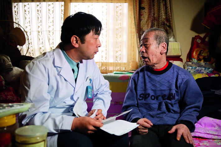 April 3, 2018: Zhao Sheng, a physician at Erqibei Community Healthcare Center in Fengtai District, Beijing, conducts a physical examination of a local resident.  VCG